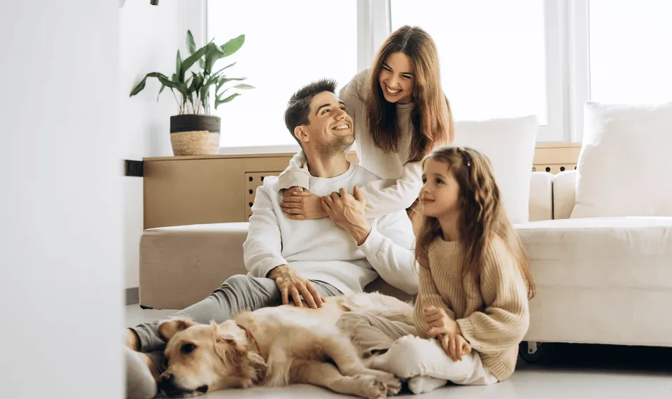 Family relaxing at home with their dog